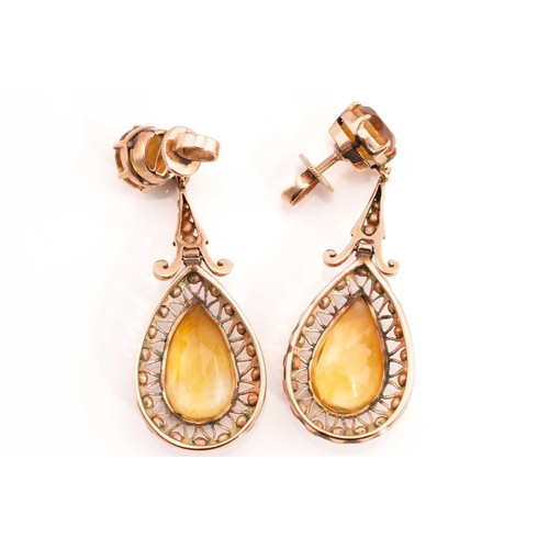 227 - A citrine demi-parure, including a pair of drop earrings, a ring and a pendant; The pair of earrings... 