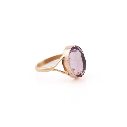 23 - An amethyst ring, consisting of an oval-cut amethyst approximately measures 14.5 x 11.2 mm, claw col... 