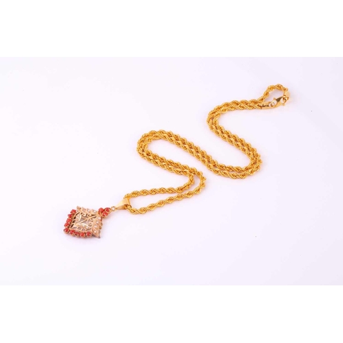 233 - A precious coral and seed pearl pendant on a twisted rope chain, the pendant of foliate design compr... 