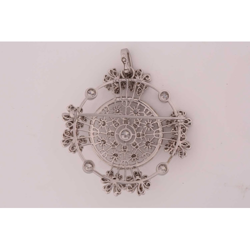 234 - A diamond brooch cum pendant; circular with a central diamond set openwork foliate cluster within a ... 