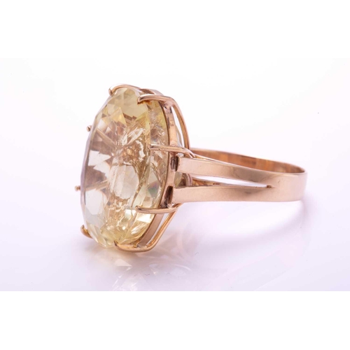 238 - A large citrine ring, featuring an oval mixed-cut citrine in a pale yellow colour, with a prominent ... 