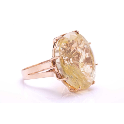 238 - A large citrine ring, featuring an oval mixed-cut citrine in a pale yellow colour, with a prominent ... 