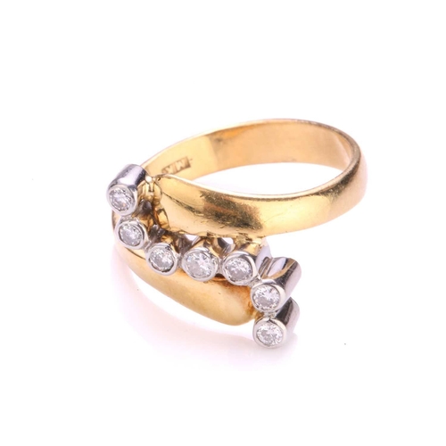 242 - A diamond bypass ring in 18ct gold, containing seven brilliant-cut diamonds in collet setting, on a ... 