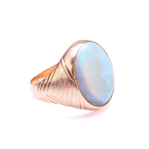 247 - A signet ring set with precious opal, where the oval cabochon displaying mild play-of-colours rangin... 