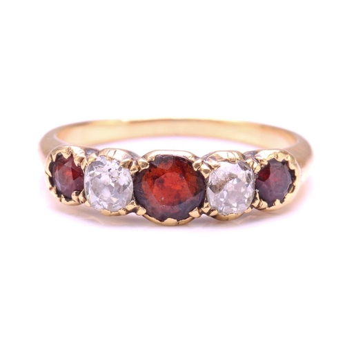 251 - A Garnet and Diamond five-stone ring, set with a central red Garnet flanked by two old round diamond... 