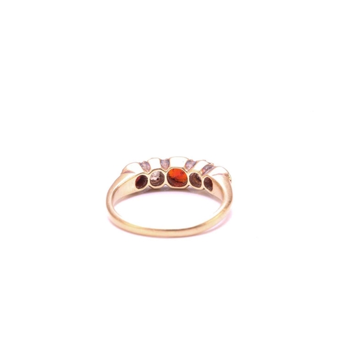 251 - A Garnet and Diamond five-stone ring, set with a central red Garnet flanked by two old round diamond... 