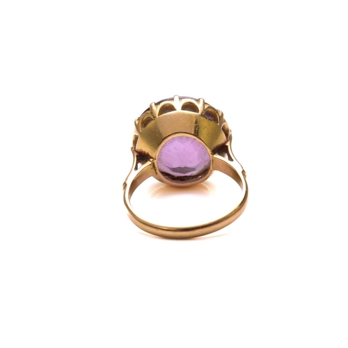 27 - An amethyst dress ring, comprising a round mixed-cut amethyst of size 14.8 mm, mounted in coronet se... 