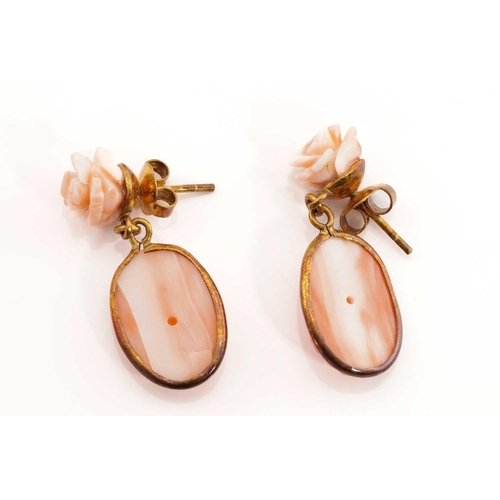 271 - Two pairs of coral earrings, including a pair of floral drop earrings, each consists of an oval carv... 