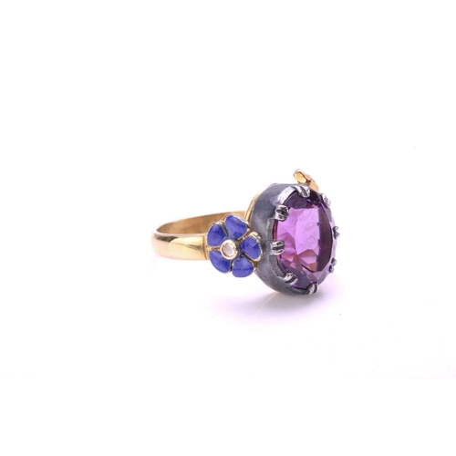 272 - An amethyst dress ring with 18ct gold and silver, comprises an oval-cut amethyst in silver open-back... 