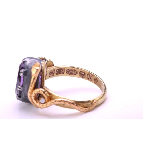 272 - An amethyst dress ring with 18ct gold and silver, comprises an oval-cut amethyst in silver open-back... 