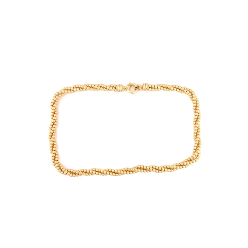 281 - A bead torsade necklace in yellow metal, fastened with a thick spring-ring clasp, Italian hallmarked... 