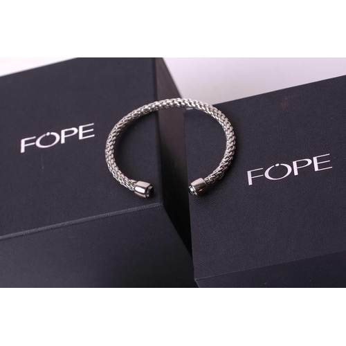 29 - FOPE - A Silver Fope bangle with sapphires from the 'Ice' collection, comprising an open bangle with... 