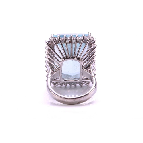 292 - A large aquamarine and diamond cluster ring, featuring a rectangular step-cut aquamarine with pale b... 