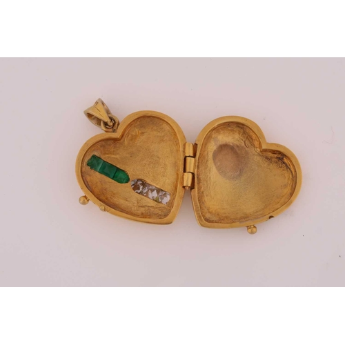 293 - An emerald and diamond set heart-shaped locket; hinged, with a diagonal band of three calibré cut em... 