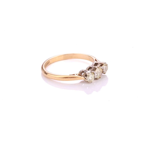 304 - A three-stone diamond ring, consisting of three old-cut diamonds with a light yellow tint, in corone... 