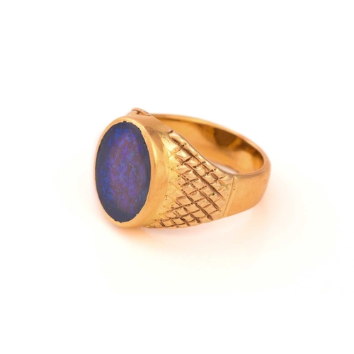 307 - A black opal signet ring, featuring an oval precious opal panel, translucent body with a dark backgr... 