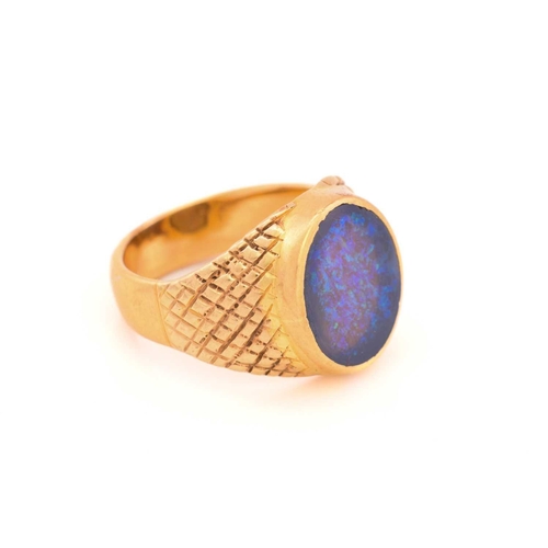 307 - A black opal signet ring, featuring an oval precious opal panel, translucent body with a dark backgr... 