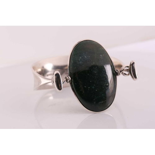 333 - Georg Jensen - 'Arm Ring' with moss agate, a tension clamp opening bangle with an oval moss agate pa... 