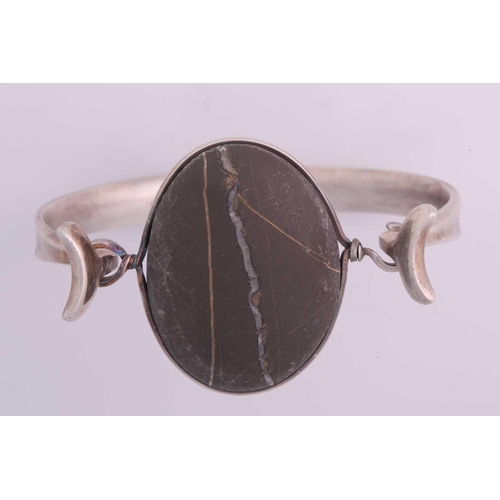 336 - Torun - 'Arm Ring' with polished rock, a tension clamp opening bangle with an oval polished rock pan... 