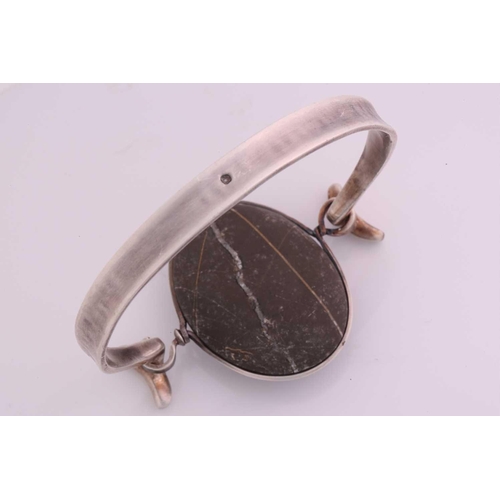 336 - Torun - 'Arm Ring' with polished rock, a tension clamp opening bangle with an oval polished rock pan... 