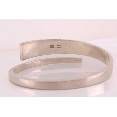 338 - A Georg Jensen bangle designed by Hans Hansen, tapering, open-ended squared band; Stamped marks and ... 