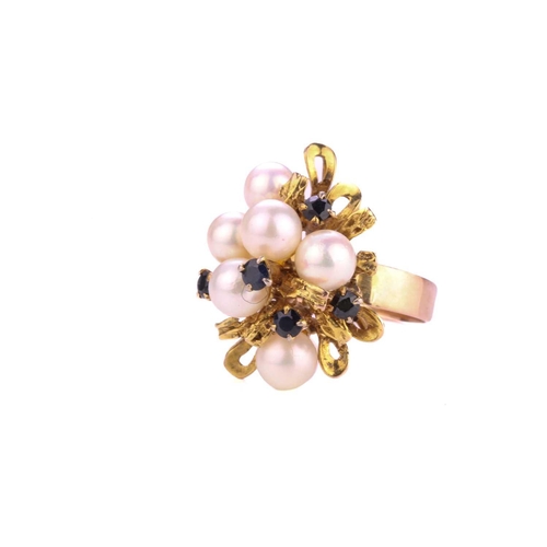 34 - A dress ring with cultured pearls and sapphires, emanating with six cultured pearls in a yellow meta... 