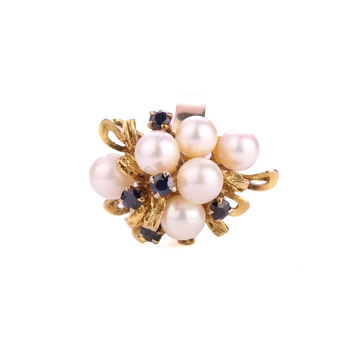 34 - A dress ring with cultured pearls and sapphires, emanating with six cultured pearls in a yellow meta... 