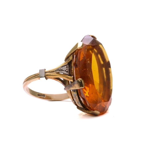 35 - A large citrine dress ring in 18ct yellow gold, featuring an oval-shaped mixed-cut citrine with deep... 