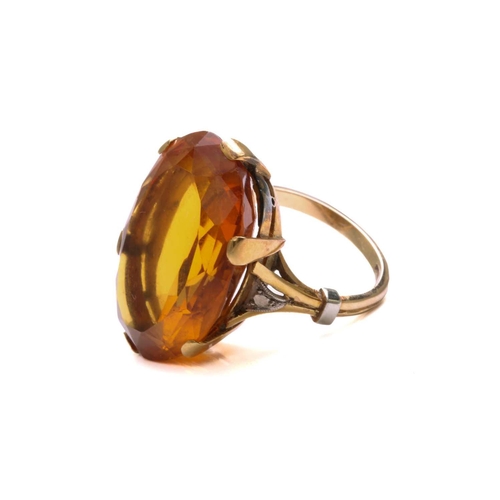 35 - A large citrine dress ring in 18ct yellow gold, featuring an oval-shaped mixed-cut citrine with deep... 