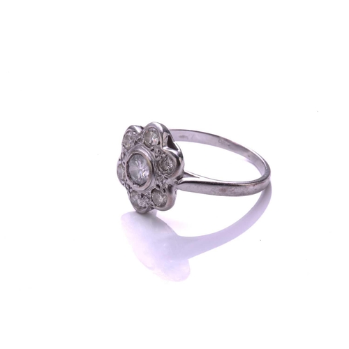 36 - A diamond cluster ring; the seven stone round brilliant cut diamond cluster in flowerhead setting to... 