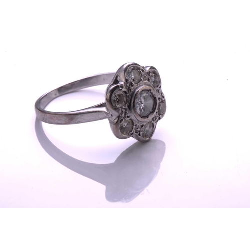 36 - A diamond cluster ring; the seven stone round brilliant cut diamond cluster in flowerhead setting to... 