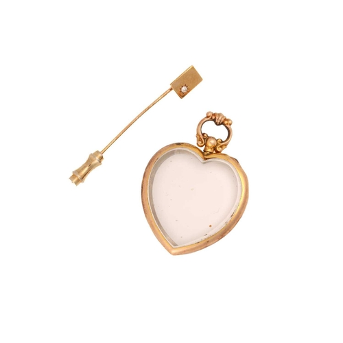 37 - A 9ct yellow gold heart pendant and tie pin; the thick glass has been fitted into a heart-shaped mou... 