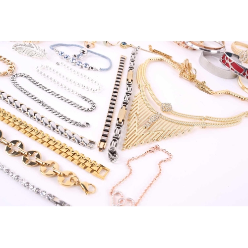 38 - A quantity of assorted base metal costume jewellery comprising various hinged bangles, line bracelet... 