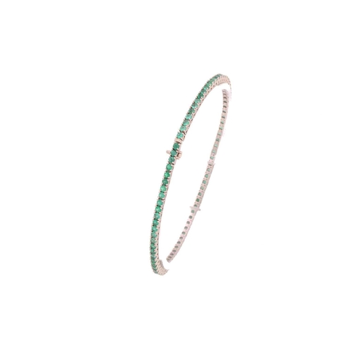 39 - An emerald line bracelet, comprising circular-cut emeralds, claw-set in articulated links, fastens w... 