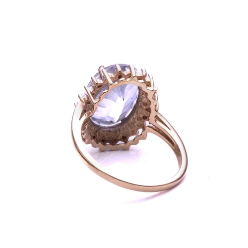 4 - A Diamond and mystic quartz cluster ring; the oval cut purplish coated quartz within a border of bea... 