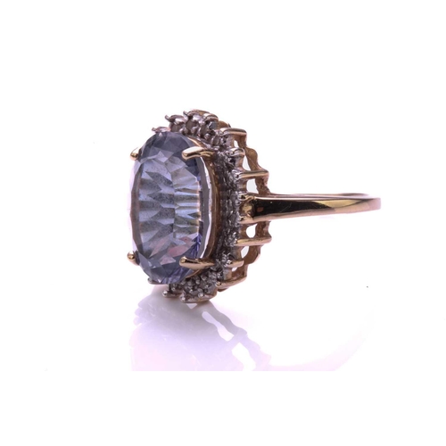 4 - A Diamond and mystic quartz cluster ring; the oval cut purplish coated quartz within a border of bea... 