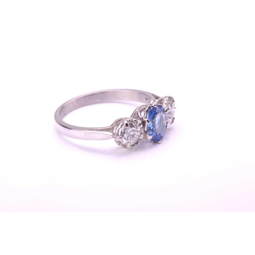 41 - A sapphire and diamond three-stone ring, consisting of an oval-cut sapphire with medium blue colour,... 