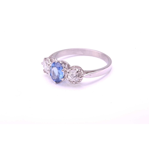 41 - A sapphire and diamond three-stone ring, consisting of an oval-cut sapphire with medium blue colour,... 