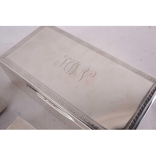 424 - Two silver cigarette boxes both of rectangular form, one with a Greek key border engraved with initi... 