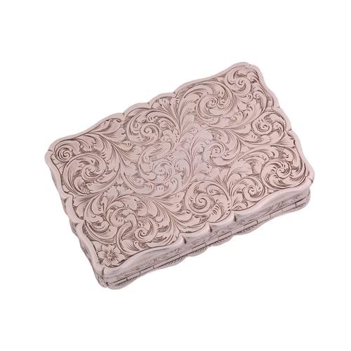 427 - A Victorian silver snuff box of shaped rectangular form allover decorated with scrolling flowering f... 