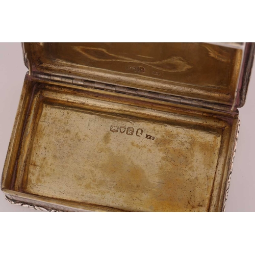 428 - A George IV silver snuff box, rounded rectangular with applied, cast foliate border, engine-turned c... 