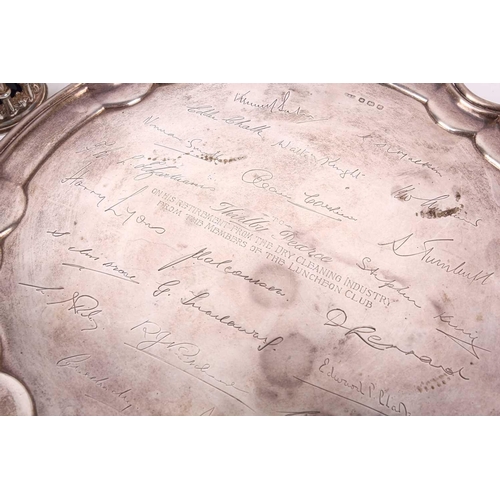 447 - A silver salver; circular with raised pie crust border; commemorative engraving to centre with facsi... 