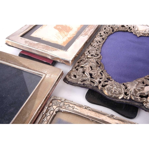 460 - A collection of seventeen silver fronted easel photograph frames to include an enbosed and pierced f... 