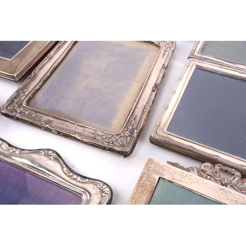 460 - A collection of seventeen silver fronted easel photograph frames to include an enbosed and pierced f... 