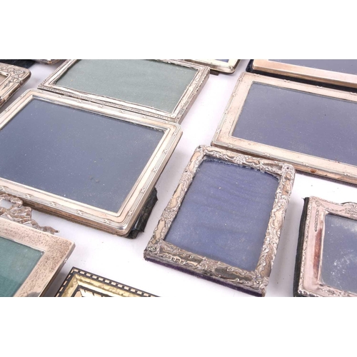 460 - A collection of seventeen silver fronted easel photograph frames to include an enbosed and pierced f... 