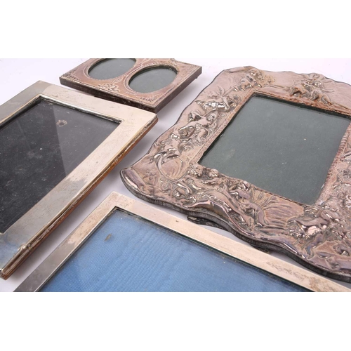 467 - A collection of twelve silver fronted easel photograph frames including , a modern embossed photo fr... 