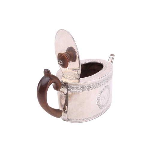 468 - A small Victorian bachelor teapot, in George III style, oval with foliate engraved bands and a crest... 