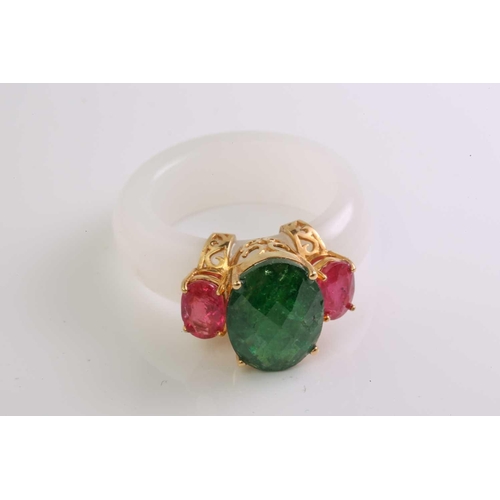 48 - A carved white nephrite jade ring set with tsavorite and rubies, with a D-section band carved out of... 