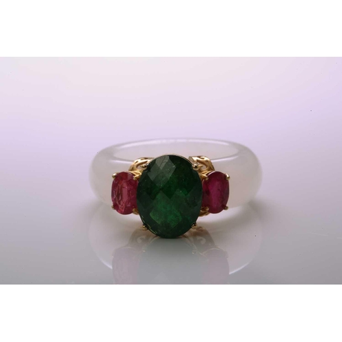 48 - A carved white nephrite jade ring set with tsavorite and rubies, with a D-section band carved out of... 