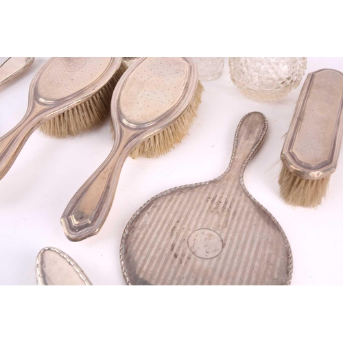 491 - A collection of silver items of silver backed dressing table appointments including brushes, mirror,... 